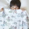 boy in bedding with nordic houses and nature seamless pattern design