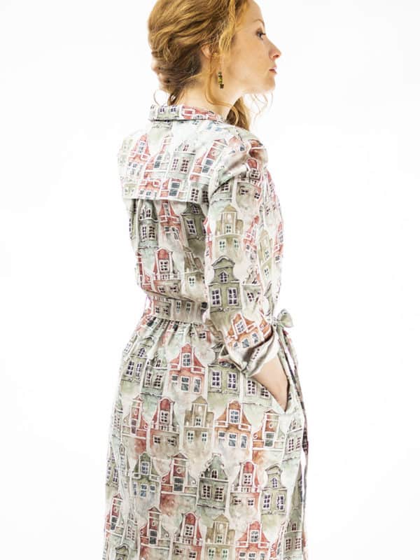 model presenting a dress with seamless pattern design with tenement houses