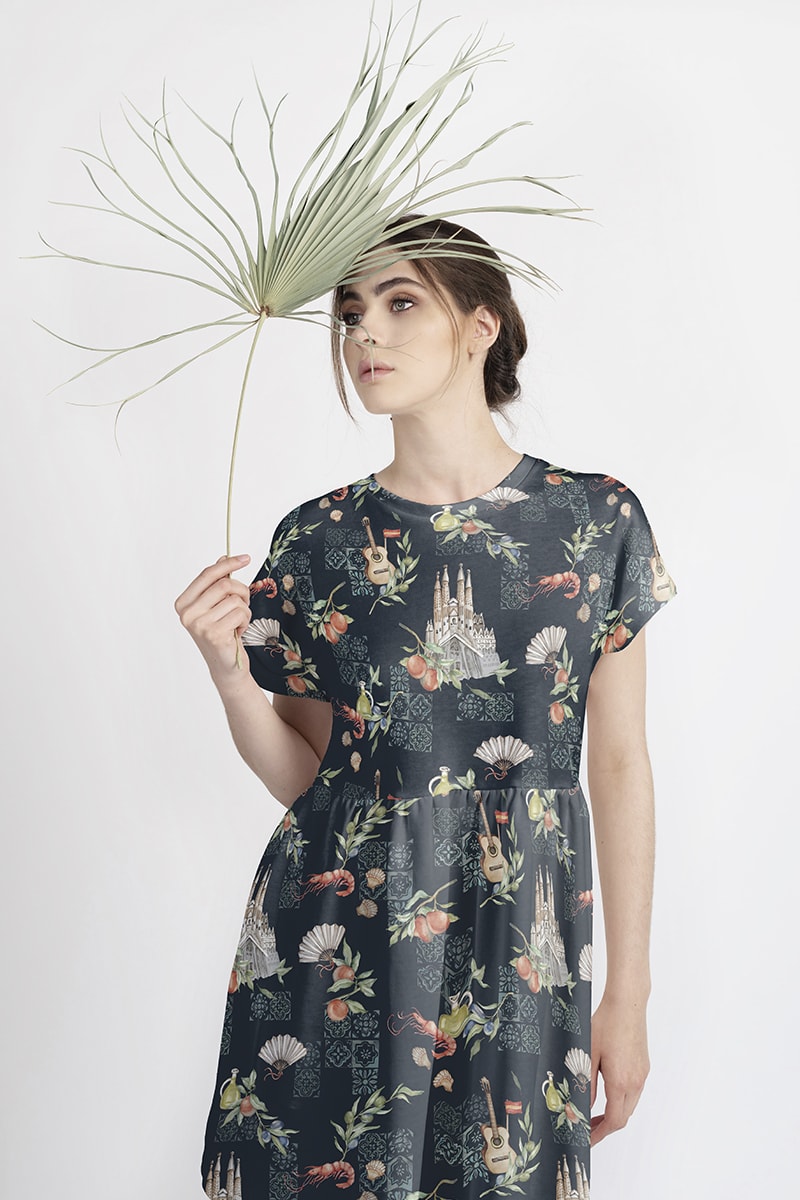 model with pal leaf presenting dress with mediterranean pattern design
